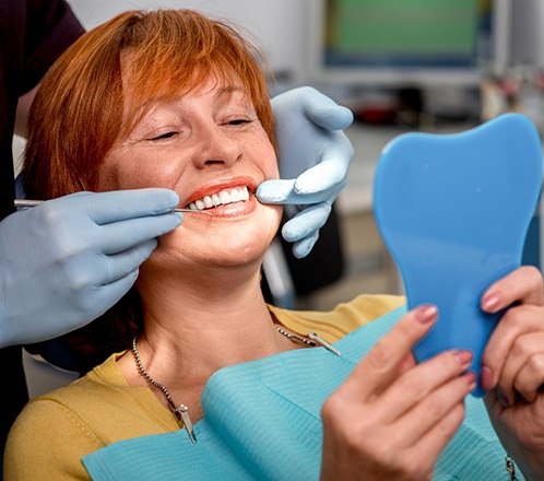 woman smiling while visiting dentist