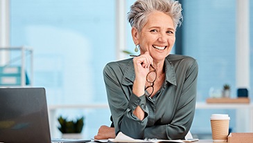 Woman smiling at her desk