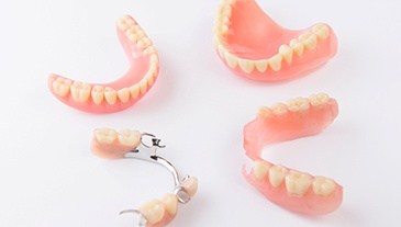 Set of full and partial dentures on a white background