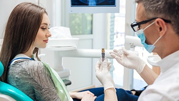 Dentist explaining the dental implant process to his patient