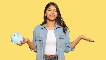 Woman holding a blue piggy bank shrugging