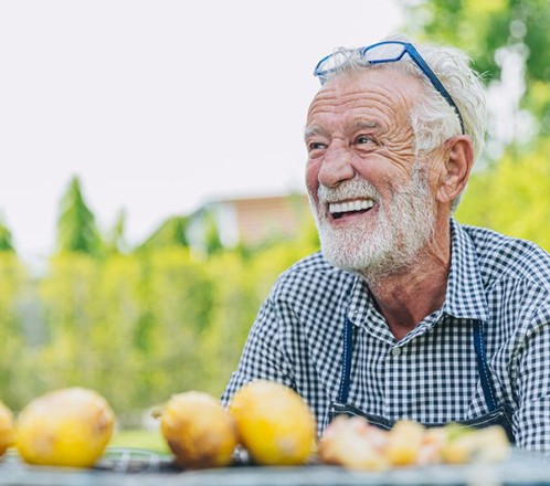 Man smiles at picnic table