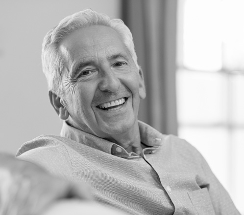 Man smiling after treatment for halitosis