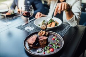 a person eating a steak dinner