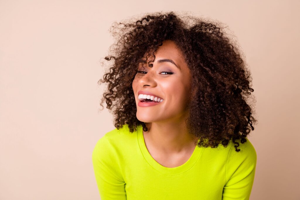 Woman in chartreuse sweater smiling