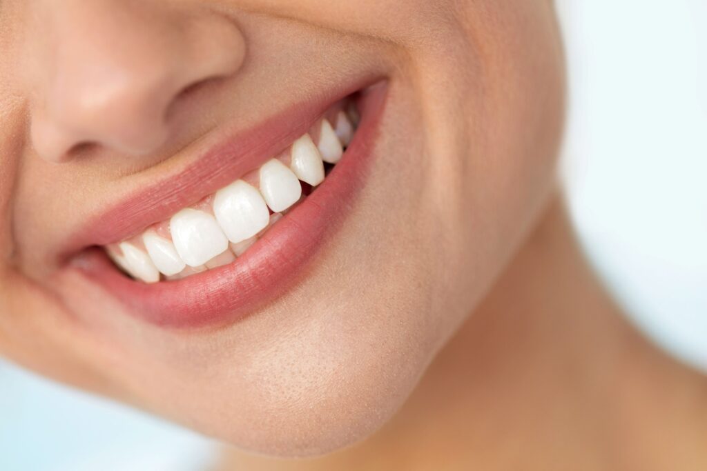 Nose-to-neck view of woman smiling