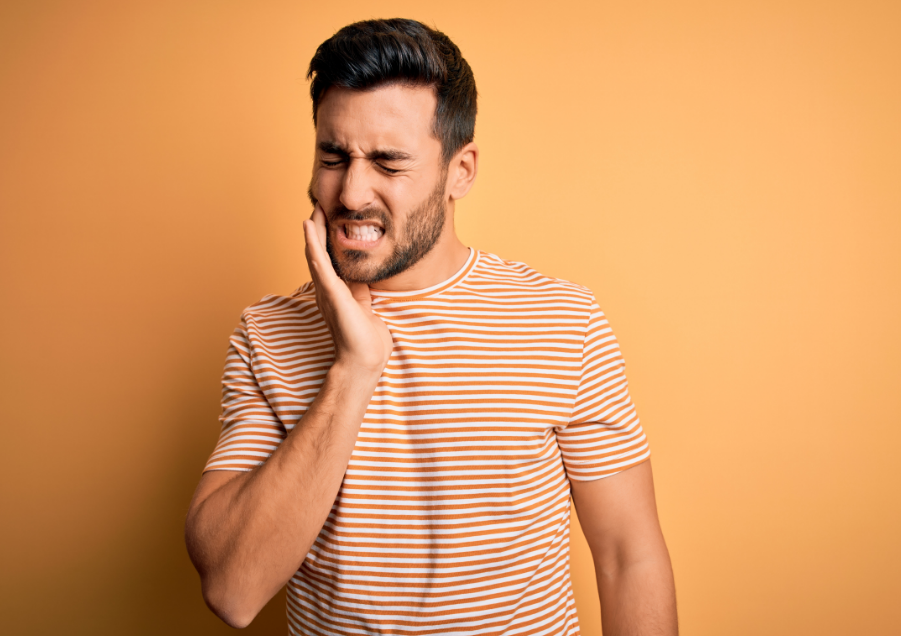 Man holding jaw in pain