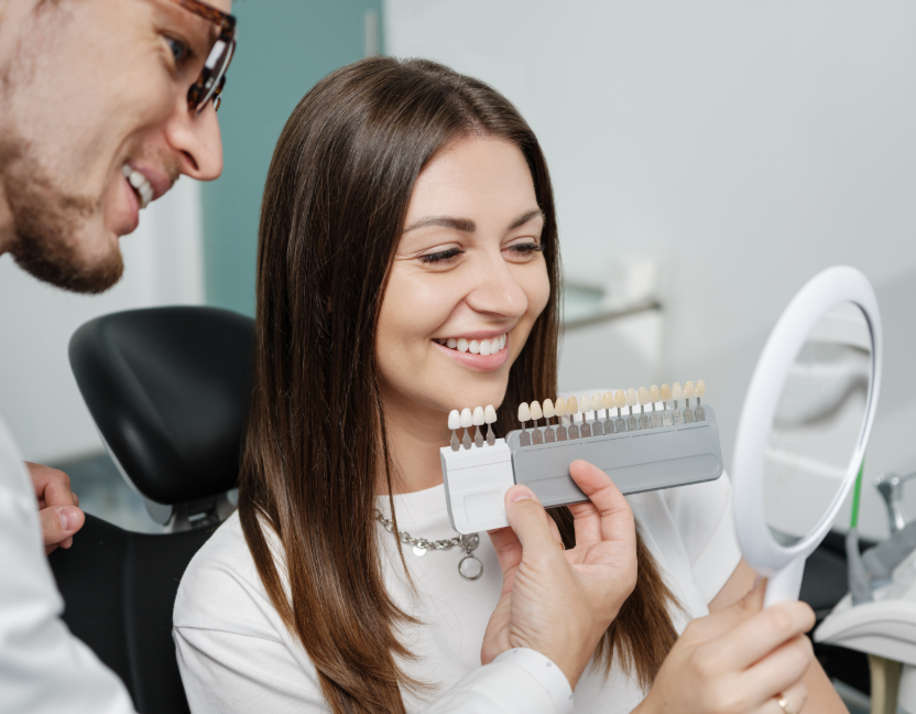 Dentist showing patient veneer options