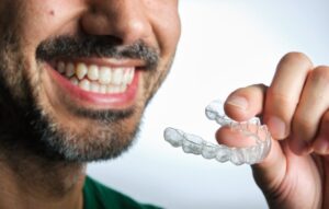 Man putting on his SureSmile tray